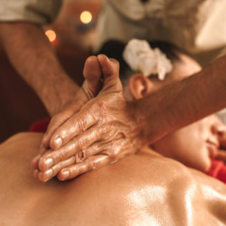 Alternative Medicine. Therapist healing woman doing ayurvedic massage with herbal oil close-up
